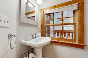a bathroom with a sink and a window at Mullen Chalet in Greenwood +37 photos
