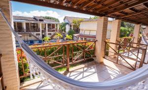 an image of a hammock on the balcony of a house at Pousada Bicho Preguiça in Pipa