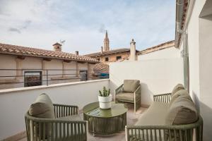 a patio with chairs and a table on a balcony at Can Savella - Turismo de Interior in Palma de Mallorca