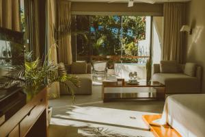 a living room with a couch and a table at Secret Garden Hideaway in Balcheil