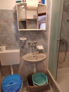 a small bathroom with a sink and a toilet at Apartments Darko in Vir +34 photos