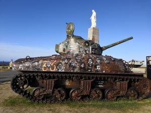 a tank on display on the side of a road at Gîte La Buhennerie 2 personnes in Longues-sur-Mer +22 photos