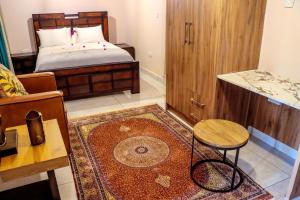 a bedroom with a bed and a table and a rug at GT holiday home in Chobe