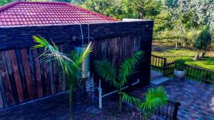 a house with a fence and some plants at GT holiday home in Chobe