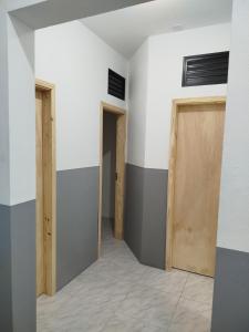 an empty room with two doors and a hallway at Republica Fusinato in Itajaí