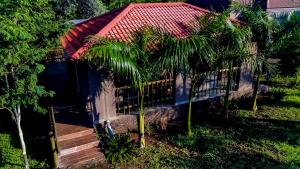 a small house with palm trees in front of it at GT holiday home in Chobe