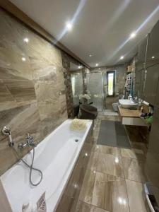 a large bathroom with a tub and a sink at Apartmán NAVRCHU in Brezno +45 photos