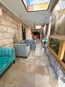 a living room with a couch and a chair at Acacia Boutique Hotel in San Juan