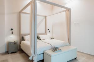 a bedroom with a canopy bed and a table at Ca' del Volo in Grezzana