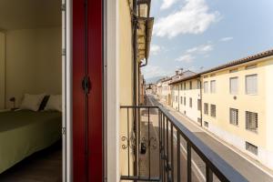 a balcony with a bed and a view of a street at Dama Apartments in San Vito di Leguzzano