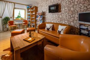 a living room with a couch and a table at Gästehaus Heißenlehen in Ramsau +44 photos