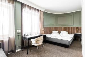 a hotel room with a bed and a desk at Comfort Hotel Linköping City in Linköping
