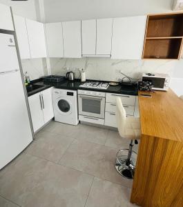 a kitchen with white cabinets and a stove top oven at Helena Resort & Spa in Kalecik