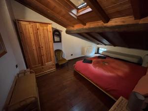 a bedroom with a large red bed in a room at Ca’ Adele in Morbegno