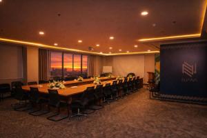 a large conference room with a long table and chairs at Eliana Hotel in Al Khobar +51 photos