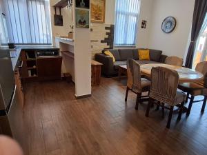 a living room with a couch and a table and chairs at Lovran centar, apartman Gega in Lovran