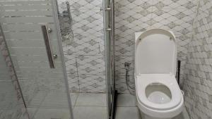 a bathroom with a toilet in a stall at Kigali Great Garden in Kigali +24 photos