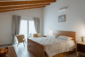 a bedroom with a bed and a table and chairs at Ca' del Volo in Grezzana
