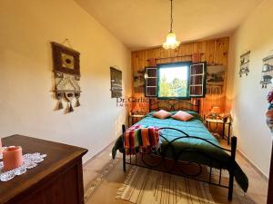 a bedroom with a bed and a window and a table at Tropical Paradice Villa in Icod de los Vinos +45 photos
