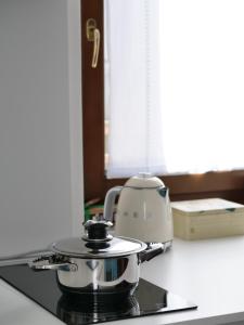 a pot sitting on top of a stove in a kitchen at Casa Nausicaa in Pergine Valsugana +10 photos