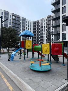 a park with a playground with a slide at Silk Road Retreat City Center in Bukhara