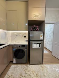 a kitchen with a stove and a dishwasher and a refrigerator at Silk Road Retreat City Center in Bukhara