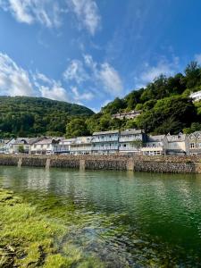 a row of houses on the shore of a river at Riverside Cottage B&B in Lynmouth