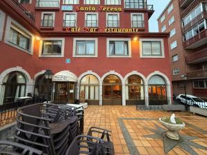 a large red building with a fountain in front of it at Hotel Santa Teresa in Ávila