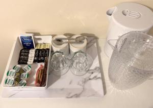 a white tray with drinks and other items on a counter at Comfortable double room with own bathroom in Inshes