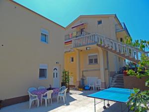 a patio with a table and chairs and a building at Apartment Anja in Tivat