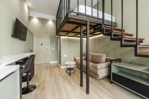 a living room with a loft bed and a couch at Amel's Rooms by PikHost in Tirana