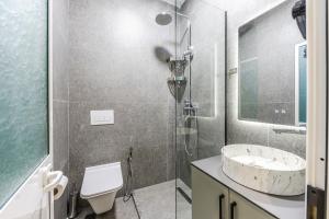 a bathroom with a shower and a sink and a toilet at Amel's Rooms by PikHost in Tirana +17 photos