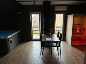 a dining room with a table and a tub at Wellness & Spa Zaprešić in Jablanovec