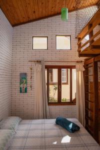 a room with a bed and a window in it at Casa Mohini Refúgio nas montanhas de Teresópolis Quarto com deck rede suspensa, lareira e cachoeira in Teresópolis +19 photos