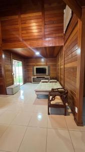 a large room with wooden walls and a large room with at Casa Guarapari in Guarapari