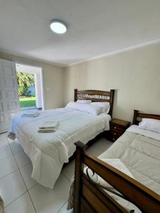a bedroom with two beds and a window at Luxurious Quinta House in Fernando de la Mora +47 photos