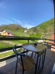 a table and a chair on a balcony with a view at Wellness & Spa Zaprešić in Jablanovec