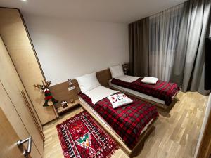 two beds in a small room with christmas decorations at A63 Premium apartment located in hotel Vucko-private host in Jahorina
