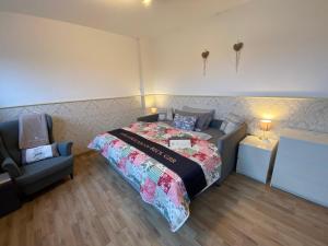 a bedroom with a bed and a chair at Ferienzimmer 2 Engelmann-Beck in Hanstedt