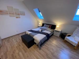 a bedroom with a bed and a chair in it at Ferienzimmer 1 Engelmann-Beck in Hanstedt