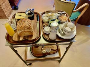 a table with a tray of food and drinks on it at Bed and Breakfast Rotterdam in Rotterdam +28 photos