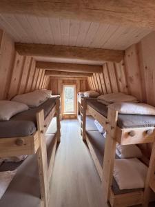 a room with four bunk beds in a cabin at Gluba Lavvo in Harkmark +28 photos