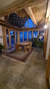 a dining room with a table and chairs on a rug at Doppelzimmer in Boutique Hostel in Pfronten