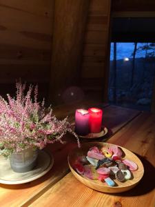 a table with two plates of food and two candles at Gluba Lavvo in Harkmark