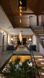 a lobby with a staircase and a living room at Doppelzimmer in Boutique Hostel in Pfronten