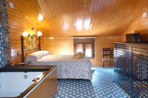 a bedroom with a bed with a teddy bear on it at Cuencaloft Casa Rural Eloy in Carboneras de Guadazaón
