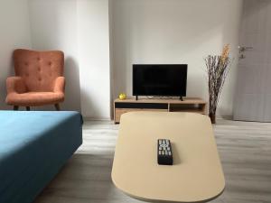 a remote control sitting on a coffee table in a living room at Capital Gate Guest House in Skopje