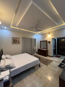 a bedroom with a large bed in a room at Urban Villa in Islamabad