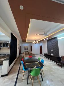 a living room with a table and chairs and a couch at Urban Villa in Islamabad