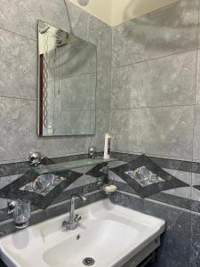a bathroom with a sink and a mirror at Urban Villa in Islamabad +36 photos